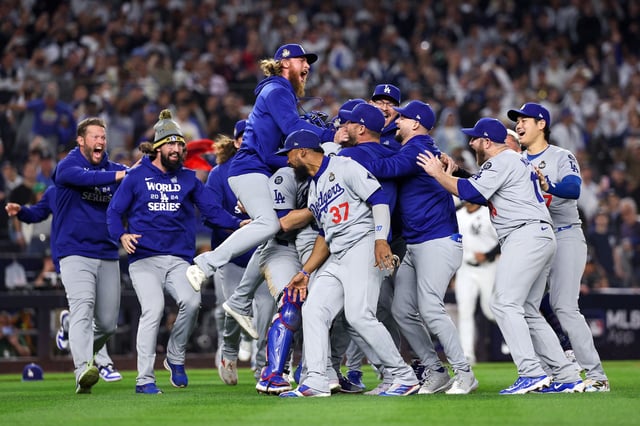 The Los Angeles Dodgers celebrate as the they defeat the New York Yankees 7-6 in Game 5 to win the 2024 World Series at Yankee Stadium.