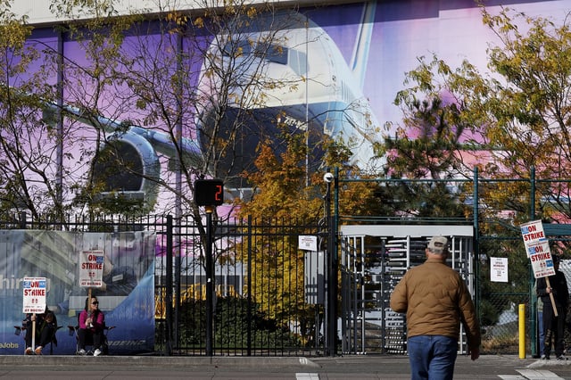 Employees work the picket line after union members voted to reject a new contract offer from the company outside the Boeing manufacturing facility, on October 24 in Renton, Washington.