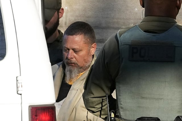 Officers escort Richard Matthew Allen out of the Carroll County courthouse following a hearing, in Delphi, Ind., Nov. 22, 2022.