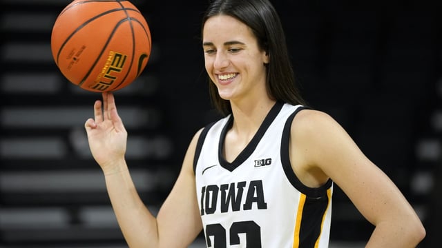 Iowa guard Caitlin Clark poses for photographers during Iowa's NCAA college basketball media day, Wednesday, Oct. 4, 2023, in Iowa City, Iowa. (AP Photo/Charlie Neibergall)