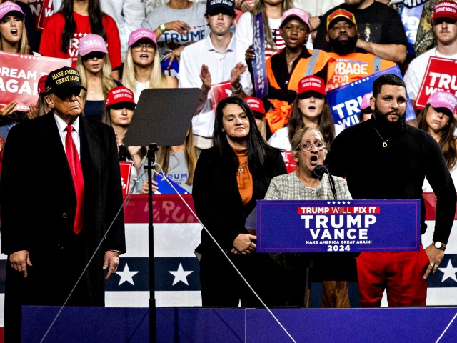 Former US President Donald Trump, left, and Carmen Ramirez, mother of Minelys "Mimi" Rodriguez Ramirez, center, during a campaign event at Atrium Health Amphitheater in Macon, Georgia, US, on Sunday, Nov. 3, 2024. A flurry of polls released Sunday show Vice President Kamala Harris and Trump remain poised for a photo finish in this week's presidential election, with voters narrowly split both nationally and across the pivotal swing states that will decide the election. Photographer: Christian Monterrosa/Bloomberg