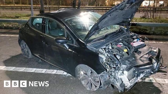 The mangled wreckage of a black car on the M8 after a drink-driver crashed his car in Glasgow and was caught after fleeing the scene wearing only one shoe