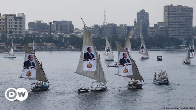 Sailboats bearing posters of Egyptian President Abdel Fattah al-Sisi take part in a rally on the River Nile