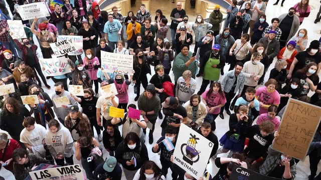 FILE - Trans-rights activists protest outside the House chamber at the state Capitol before the State of the State address in Oklahoma City, Feb. 6, 2023. In a ruling late Thursday, Oct. 5, a federal judge in Oklahoma declined to stop a new law from taking effect that makes it a felony crime for health care workers to provide gender-affirming care to young transgender people. (AP Photo/Sue Ogrocki, File)