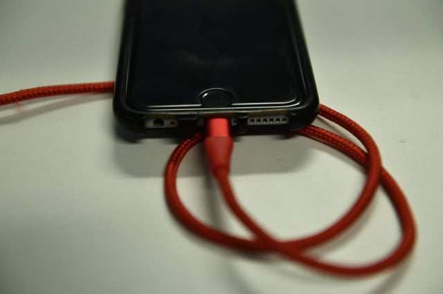 An iPhone 6S is plugged into a battery charger on March 18, 2019 in Washington,DC. (Photo by Brendan Smialowski / AFP) (Photo by BRENDAN SMIALOWSKI/AFP via Getty Images)