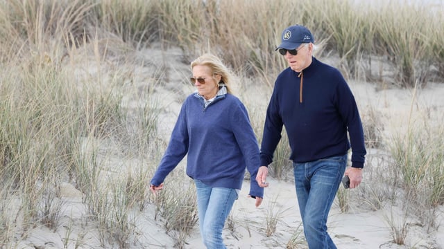 US President Joe Biden and First Lady Jill Biden walk on the beach at Gordons Pond in Rehoboth Beach, Delaware, on November 10, 2024. (Photo by Ting Shen / AFP)