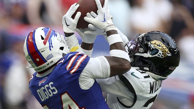 Jacksonville Jaguars cornerback Darious Williams (31) intercepts a pass for Buffalo Bills wide receiver Stefon Diggs (14) during an NFL football game between Jacksonville Jaguars and Buffalo Bills at the Tottenham Hotspur stadium in London, Sunday, Oct. 8, 2023. (AP Photo/Ian Walton)