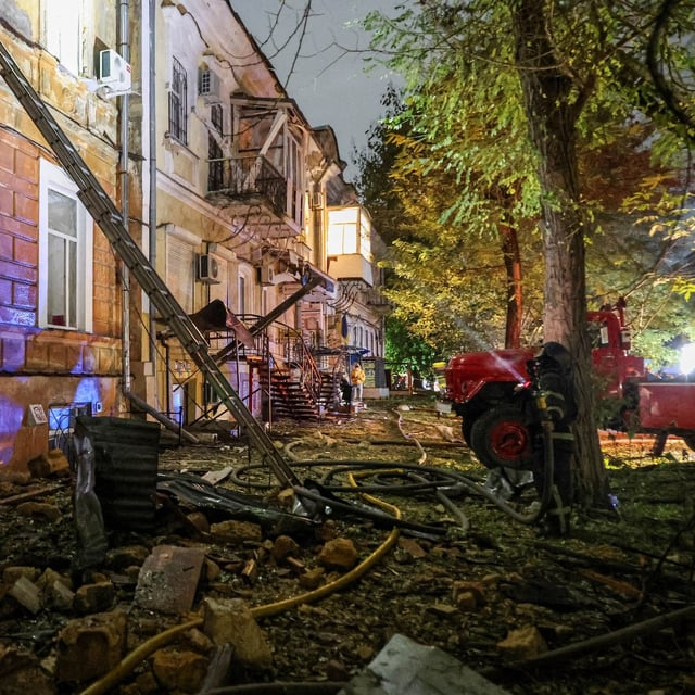 A firefighter works at a site of an apartment building damaged during Russian missile and drone strikes, amid Russia's attack on Ukraine, in Odesa, Ukraine on Nov. 15.