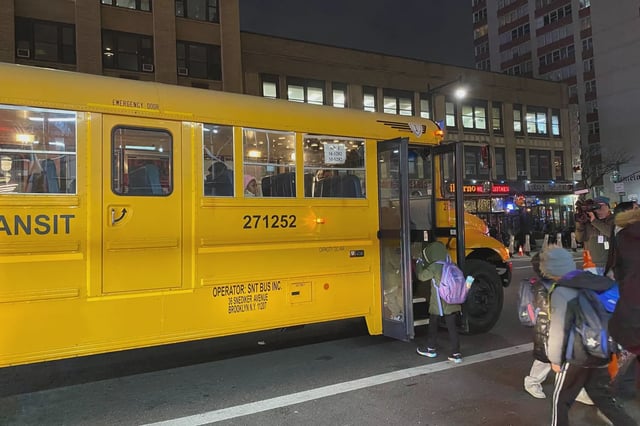 Migrant children seen boarding a school bus outside the Row Hotel in Midtown Manhattan on Jan. 9, 2024.