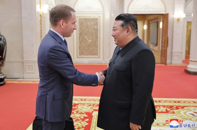 Kremlin natural resources chief Alexander Kozlov (L) meets with North Korean leader Kim Jong Un in Pyongyang
