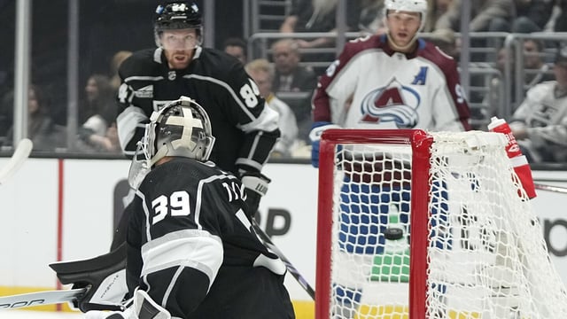 Los Angeles Kings goaltender Cam Talbot, left, is scored on by Colorado Avalanche center Nathan MacKinnon as defenseman Vladislav Gavrikov, center, and right wing Mikko Rantanen watch during the first period of an NHL hockey game Wednesday, Oct. 11, 2023, in Los Angeles. (AP Photo/Mark J. Terrill)