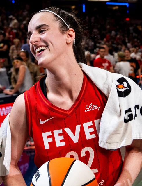 Indiana Fever guard Caitlin Clark (22) smiles in an interview after becoming the first rookie to achieve a triple-double Saturday, July 6, 2024, during the game at Gainbridge Fieldhouse in Indianapolis. The Fever defeated the Liberty, 83-78.