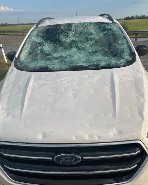 Damage to a car is shown after a hailstorm near Innisfail, Alta. in a Monday, Aug.1, 2022, handout photo. 