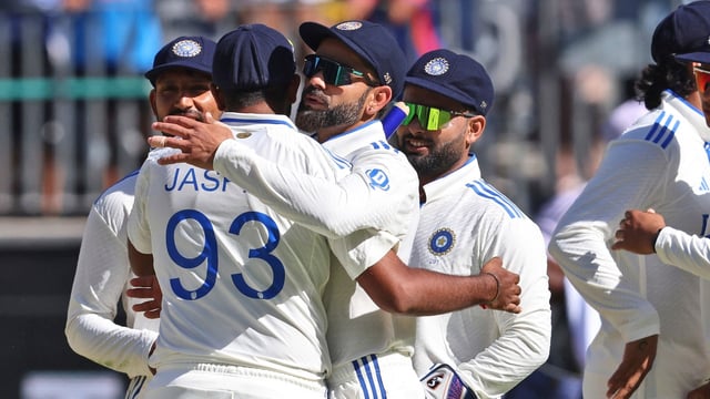 India's captain Jasprit Bumrah hugs teammate Virat Kohli after winning the first cricket test against Australia in Perth, Australia, (AP Photo/Trevor Collens)