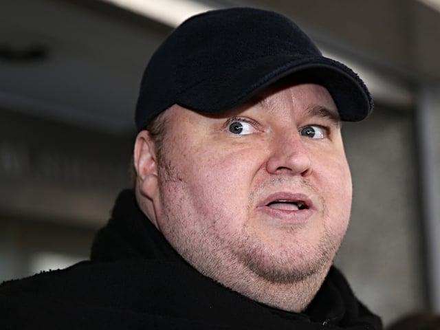 Internet mogul Kim Dotcom leaves court after a judge ruled that he and three other defendants are eligible for extradition to the US, in Auckland on December 23, 2015. A New Zealand judge ruled December 23 Internet mogul Kim Dotcom can be extradited to the United States where he is wanted on money laundering, racketeering and breach of copyright charges. AFP PHOTO / Michael Bradley (Photo by MICHAEL BRADLEY / AFP) (Photo by MICHAEL BRADLEY/AFP via Getty Images)