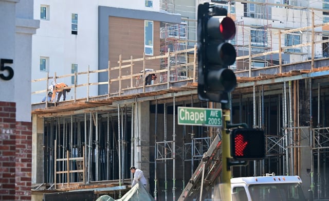 Construction workers on site at a new apartment complex being built in Alhambra, California on September 6, 2023