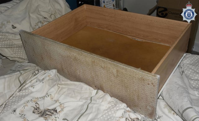 This undated handout photo issued by the Cheshire Constabulary shows the drawer where a baby was kept in, stored under her mother's bed, until she was discovered weeks before her third birthday. The mother has been jailed for seven and a half years after the child was discovered at the family home in Cheshire.