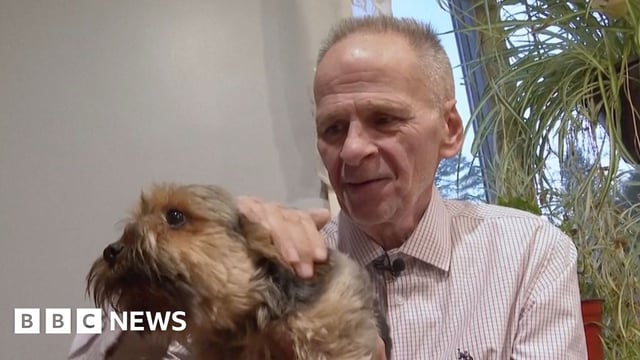 Michael Sullivan holds his dog