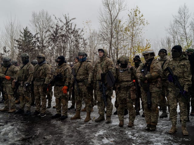 Civilians wearing military uniforms take part in a military training organized by Ukrainian soldiers of The Third Separate Assault Brigade in Kyiv, on November 23, 2024, amid the Russian invasion of Ukraine.