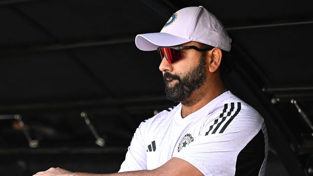 India's Rohit Sharma looks on from the pavilion. (Photo by SAEED KHAN / AFP) 