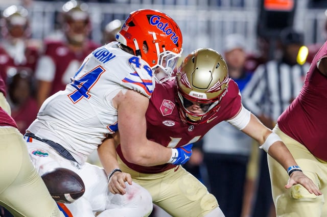 Florida&#39;s Jack Pyburn (44) strips the ball from Florida State quarterback Luke Kromenhoek, right, during the first half of an NCAA college football game Saturday, Nov. 30, 2024, in Tallahassee, Fla. Florida recovered the ball. (AP Photo/Colin Hackley)