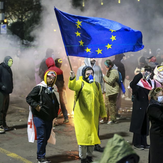 A protester waves an European Union flag during a rally outside the parliament to protest the government's decision to suspend negotiations on joining the European Union for four years in Tbilisi, Georgia, early Saturday, Nov. 30, 2024. The U.S. has suspended its strategic partnership with Georgia, condemning the ruling party for making the country "more vulnerable" to Russia as demonstrations rage on over the government in Tbilisi pulling away from the European Union and NATO.