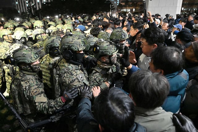 Soldiers try to enter the National Assembly building in Seoul on December 4, 2024, after South Korea President Yoon Suk Yeol declared martial law.