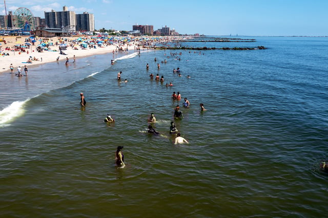 People try to keep cool in the water at Coney Island during a heat wave in Brooklyn, N.Y., on July 28, 2023.