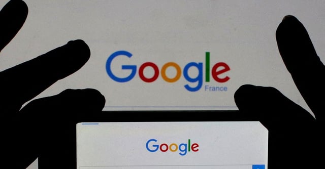 A woman holds her smart phone which displays the Google home page, in this picture illustration taken February 24, 2016. REUTERS/Eric Gaillard/Illustration/File Photo