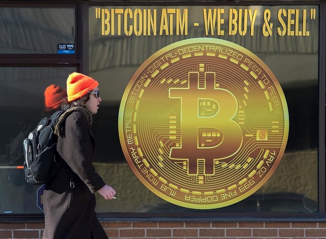 A sign advertises a Bitcoin ATM at a shop in Halifax on Wednesday, February 4, 2020. 