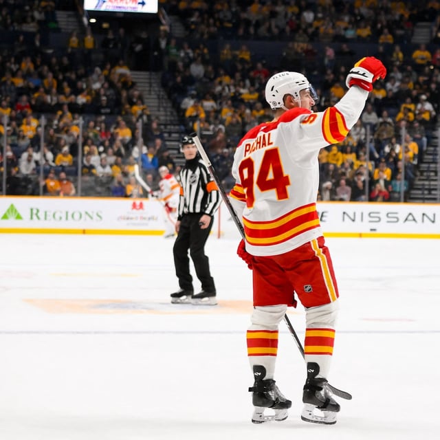 Dec 10, 2024; Nashville, Tennessee, USA;  Calgary Flames defenseman Brayden Pachal (94) celebrates his goal against the Nashville Predators during the second period at Bridgestone Arena. Mandatory Credit: Steve Roberts-Imagn Images