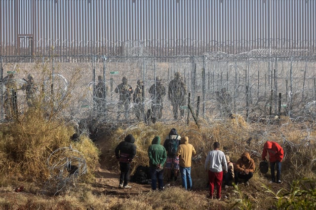 Migrants near the Rio Grande along the US-Mexico border in Juarez, Chihuahua state, Mexico, on Wednesday, December 18.