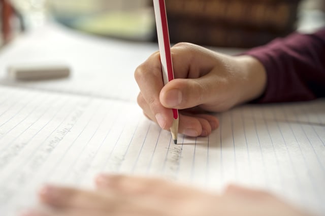 Stock photo of child doing homework