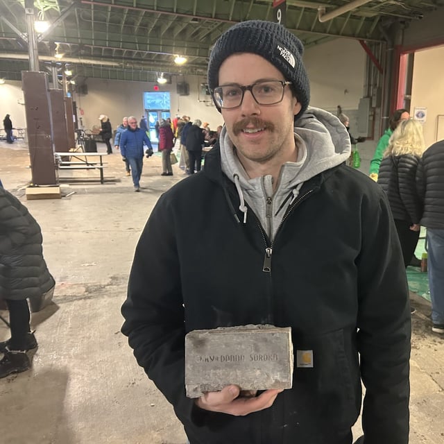 Peter Soroka displays the brick his parents purchased to support the 1988 Winter Olympics, in Calgary on Friday, Jan.3, 2025. THE CANADIAN PRESS/Bill Graveland