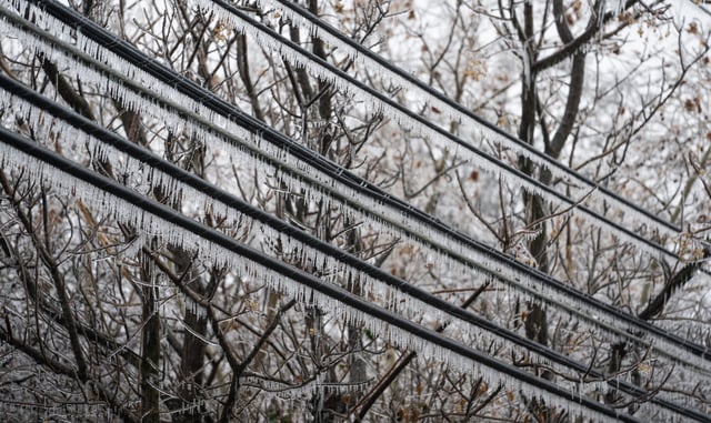 Ice-covered power lines stretch between houses in Austin as large parts of the city go without power last winter.