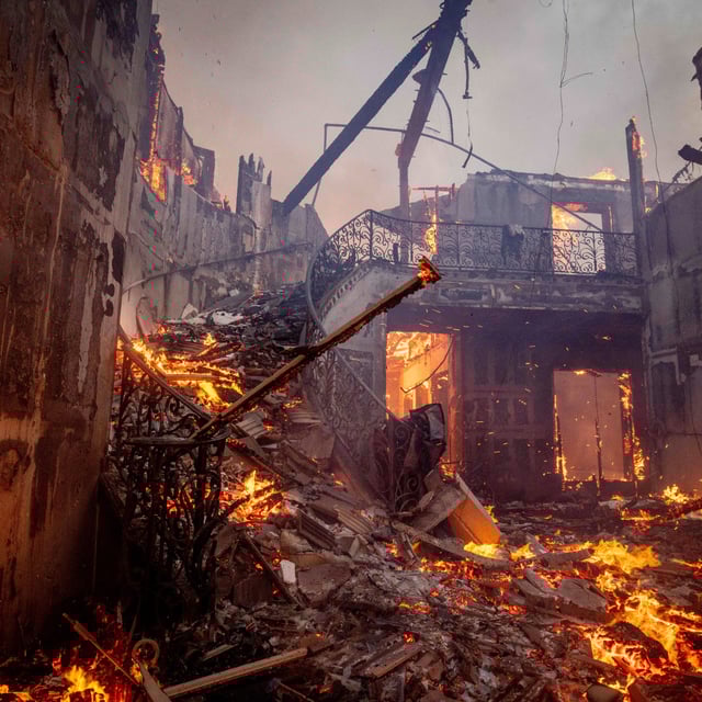The Palisades Fire burns a residence in the Pacific Palisades neighborhood of Los Angeles on January 7, 2025.