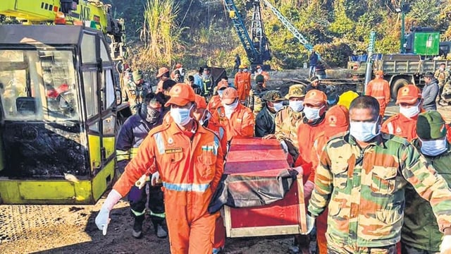 Rescue personnel carry the body of a worker recovered from an Assam mine on Saturday. (PTI)
