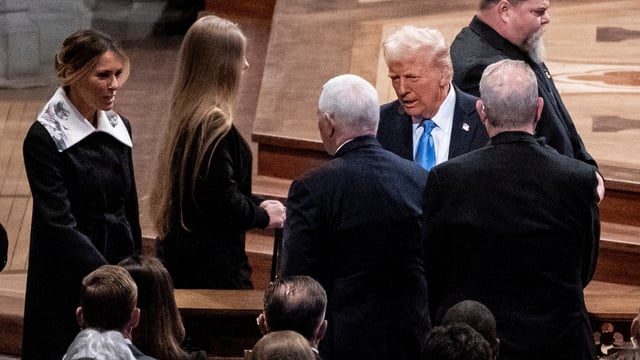 Mike Pence, second left, greets Melania Trump, left, as her husband President-elect Donald Trump, right, looks on at a state funeral for former President Jimmy Carter at the National Cathedral, Thursday, Jan. 9, 2025, in Washington. (Haiyun Jiang/The New York Times via AP, Pool)