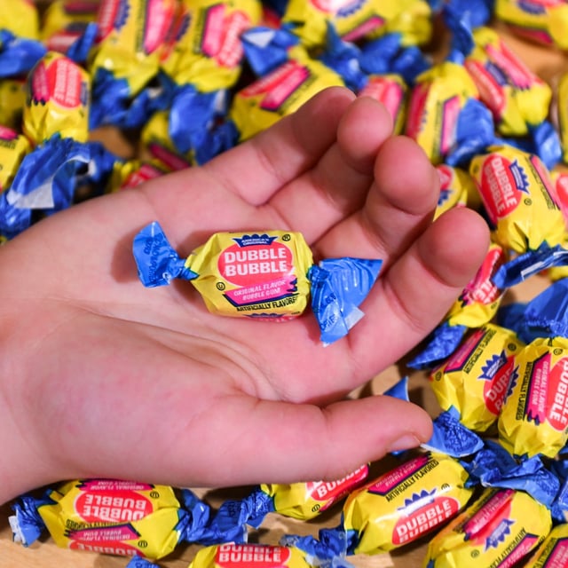 A boy holds a wrapped Dubble Bubble Bubble Gum candy in his hand, a product that uses Red Dye # 3, in this illustration photograph on December 27, 2024. The US Food and Drug Administration (FDA) on January 15, 2025 announced a ban on Red Dye No. 3, a controversial food coloring long known to cause cancer in animals, decades after scientific evidence first raised alarm. (Photo by ROBERTO SCHMIDT / AFP) (Photo by ROBERTO SCHMIDT/AFP via Getty Images)