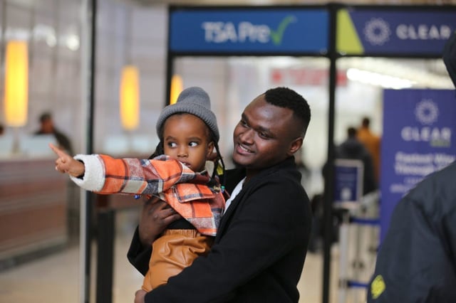 Gloire Sadiki holds his 3-year-old child after they were reunited at the Louisville's Muhammad Ali International Airport in in Louisville, KY, Jan. 14, 2025. The Congolese refugees were reunited through the U.S. refugee program.