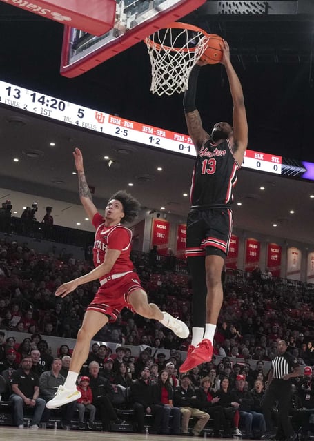 Houston forward J&#39;Wan Roberts (13) dunks the ball past Utah guard Miro Little (1) during the first half of an NCAA men’s college basketball game, Wednesday, Jan. 22, 2025, in Houston.
