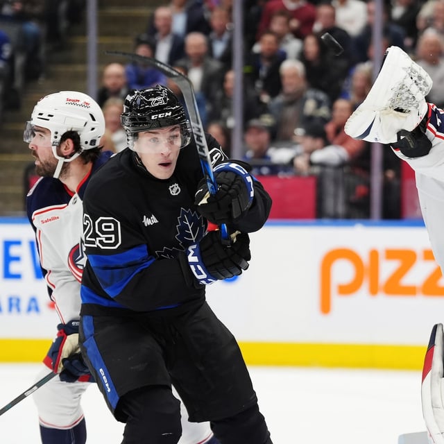 Columbus Blue Jackets goaltender Elvis Merzlikins (90) reaches for the puck in front of Toronto Maple Leafs' Pontus Holmberg (29) during second period NHL hockey action in Toronto on Wednesday, January 22, 2025. THE CANADIAN PRESS/Frank Gunn