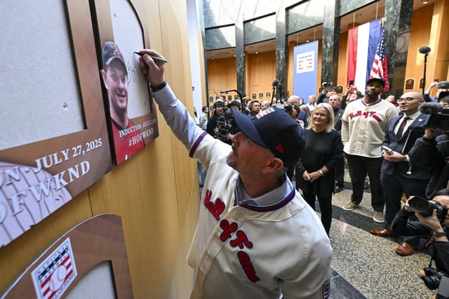 Former Astros closer and new Baseball Hall of Fame electee Billy Wagner signs the backer board where his plaque will hang during a news conference Thursday in Cooperstown, N.Y.