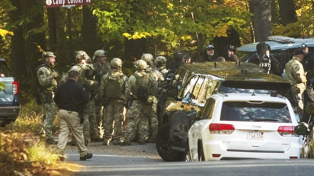 Massachusestts State Police troopers gather Tuesday, Oct. 24, 2023, at the intersection of Kelton St. and Camp Collier Road in Gardner, Mass., during a search for Aaron Pennington. Law enforcement officials are searching for Pennington, who is wanted for questioning in connection with the shooting death of his 30-year-old wife, Breanne Pennington, who was found in their home on Sunday. (Rick Cinclair/Worcester Telegram & Gazette via AP)