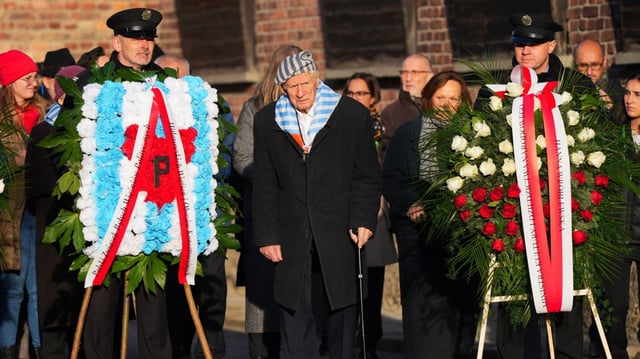 Survivors and their relatives attend a ceremony at Auschwitz on Monday