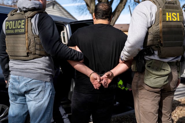 US Immigration and Customs Enforcement agents detain a suspect during a multi-agency enforcement operation in Lyons, Illinois, on Sunday. President Trump has vowed to ultimately deport all undocumented migrants living in the country.