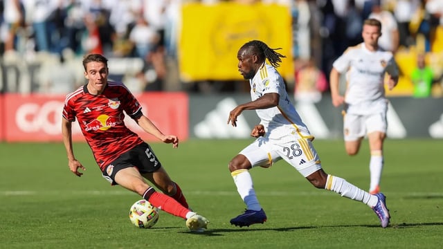 CARSON, CALIFORNIA - DECEMBER 7: Joseph Paintsil #28 of LA Galaxy dribbles the ball past Sean Nealis #5 of New York Red Bull at Dignity Health Sports Park on December 7, 2024 in Carson, California. (Photo by Jenny Chuang/ISI Photos/Getty Images)