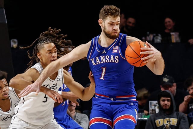 Central Florida forward Benny Williams (5) defends Kansas center Hunter Dickinson (1) during the first half of an NCAA college basketball game, Sunday, Jan. 5, 2025 in Orlando, Fla. (AP Photo/Kevin Kolczynski)