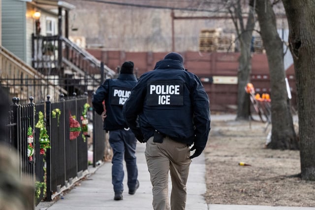 US Immigration and Customs Enforcement (ICE) agents walk down a street during a multi-agency targeted enforcement operation in Chicago, Illinois, US, on Sunday, Jan. 26, 2025. 