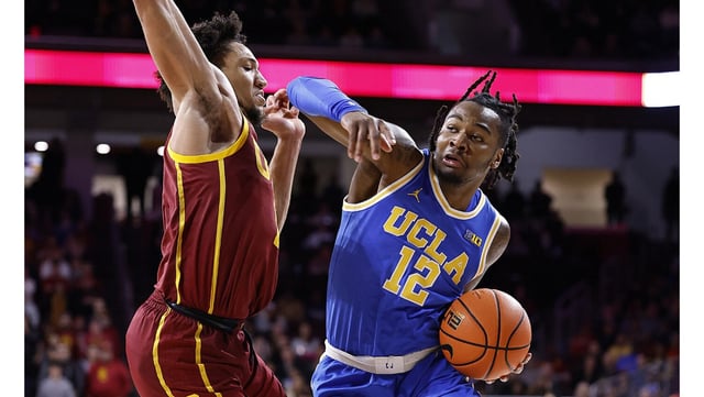UCLA’s Sebastian Mack controls the ball as USC’s Wesley Yates III defends during the second half on Monday night at the Galen Center. (Photo by Ronald Martinez/Getty Images)